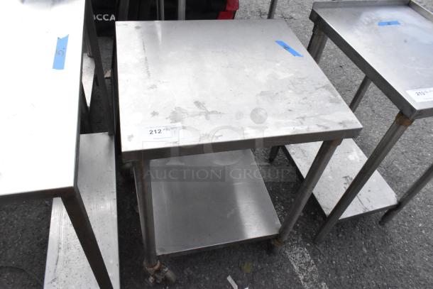 Stainless steel table with under shelf, on commercial casters. Some surface wear. Auction tag: 212 with QTY noted.