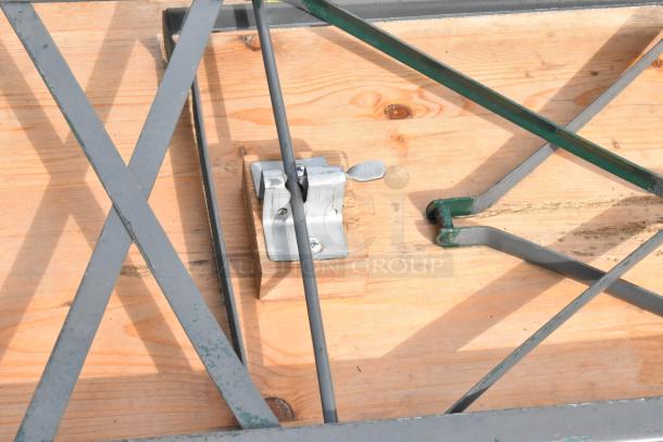 16 wooden folding tables, metal legs, locking mechanism visible, light wear, auction item offering 16 times bid value.