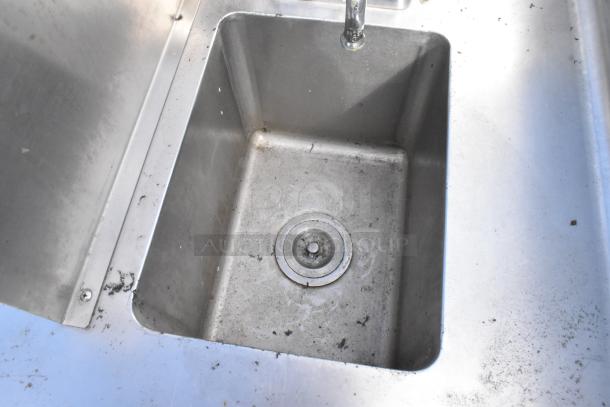 Stainless steel 2 bay sink with two faucets, used condition, surface marks and wear, ideal for commercial kitchen.
