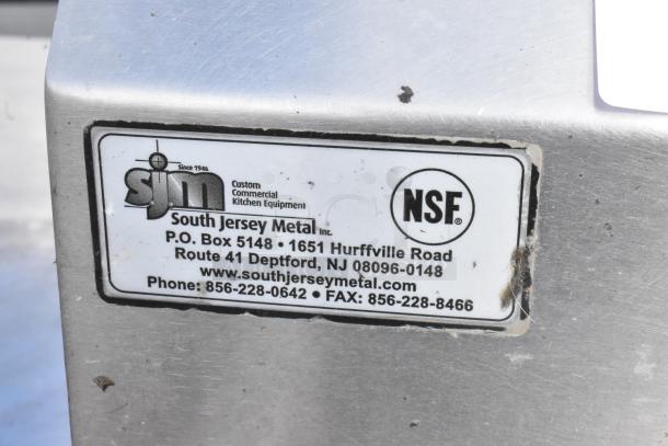Stainless Steel 2 Bay Sink by South Jersey Metal, features NSF certification label. Two faucets, ideal for commercial use.