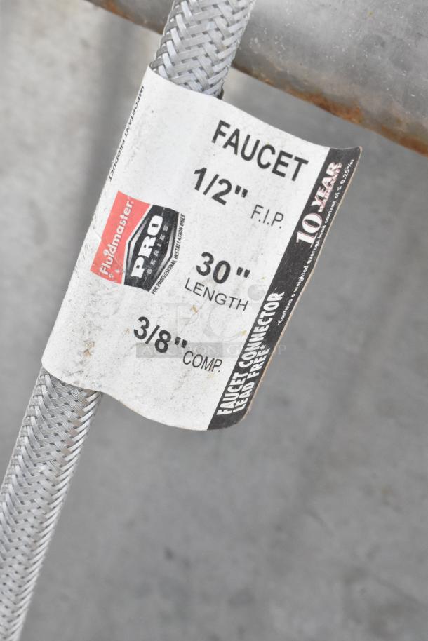 Tag on a braided hose for a stainless steel 2 bay sink with two faucets, showing specifications: 1/2" F.I.P., 30" length, 3/8" comp.