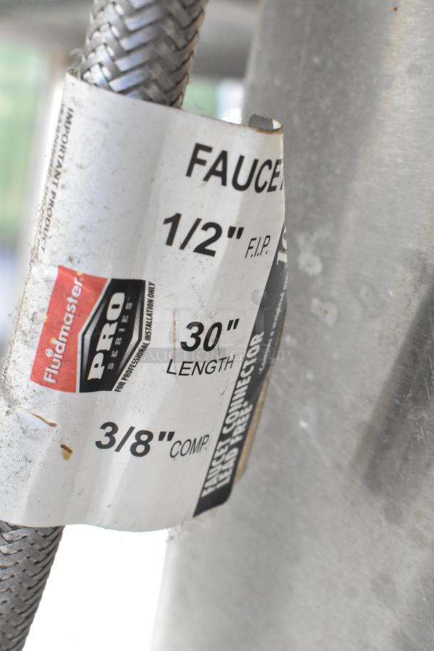 Close-up of a label on a 30" Fluidmaster Pro Series faucet connector indicating 1/2" F.I.P. and 3/8" Comp fittings.