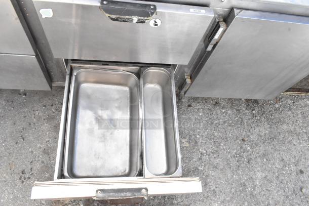 Stainless steel commercial undercounter cooler, 4 drawers, 1 door, on casters. 115V, 1 phase. Includes pans.