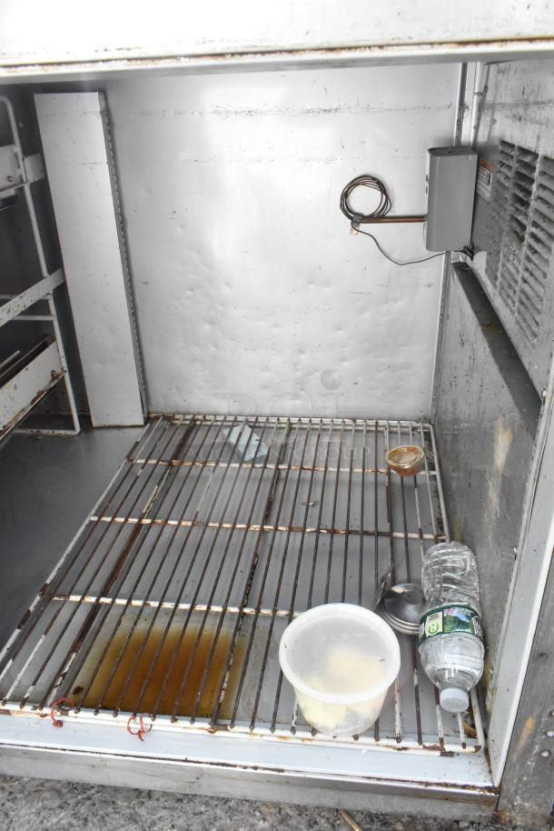 Stainless steel undercounter cooler, 4 drawers, 1 door, on casters. Visible interior shelves. 115V, 1 phase, used condition.