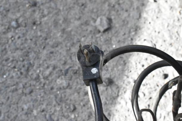 Stainless steel commercial undercounter cooler with 4 drawers, 1 door, on casters. 115V, 1 phase. Coiled power cable shown.