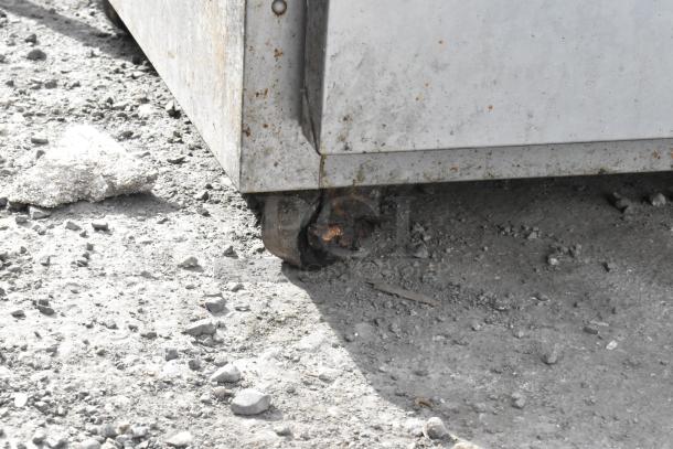 Stainless steel commercial undercounter cooler with 4 drawers, 1 door, on commercial casters. Visible wear on surface. 115V, 1 phase.