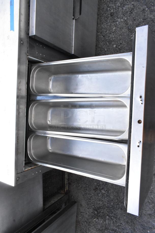 Stainless steel commercial undercounter cooler with 4 drawers and 1 door, on casters, 115 volts, 1 phase, in good condition.