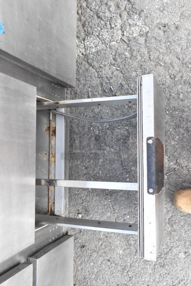 Stainless steel commercial undercounter cooler with 4 drawers, 1 door, and casters. Visible wear and rust on drawer edges. 115 volts, 1 phase.