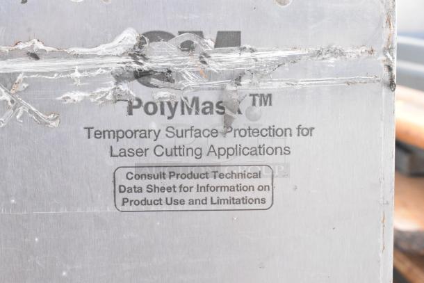 Stainless steel undercounter cooler with 4 drawers, 1 door, on commercial casters. Tag: PolyMask surface protection label.