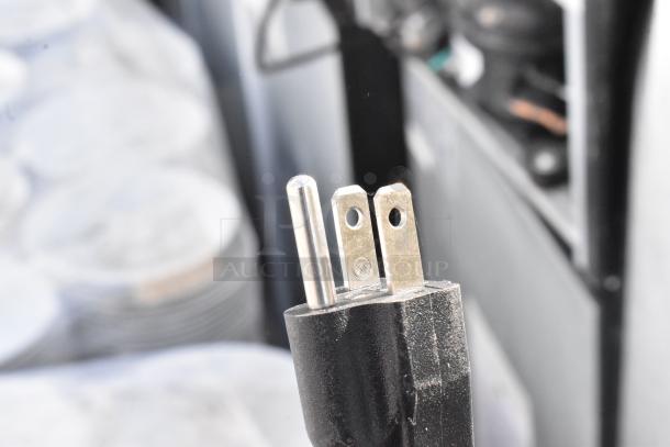 Close-up of a 115-volt plug for various mini coolers including Frigidaire and GE models. Condition appears functional.