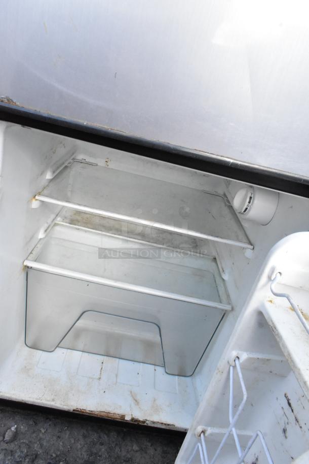 Five various mini fridges including Frigidaire EFR331, GE, Galanz; interior shown with shelves; fair condition.