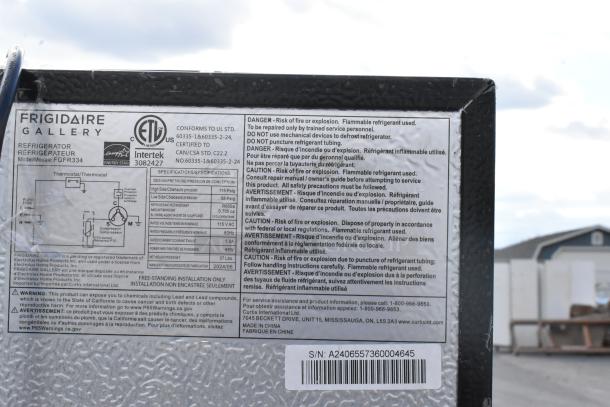 Frigidaire FGFR334 mini cooler label showing model, specifications, safety warnings, and serial number for auction.