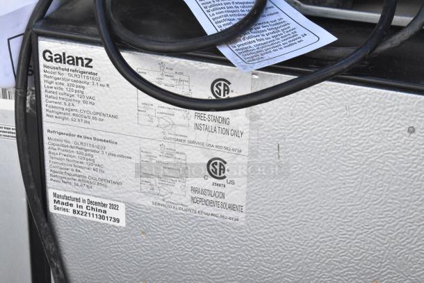 Galanz mini cooler, model GLR31TS1E02. Labels show specs: 3.1 cu ft, 115V, 1 phase. Made December 2022, China.