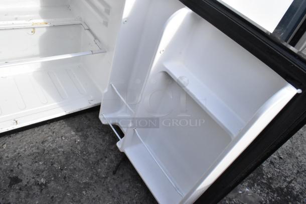 Interior view of an EdgeStar mini cooler, showcasing clean shelves and storage space. Model CMF151L, 115 volts, 1 phase.