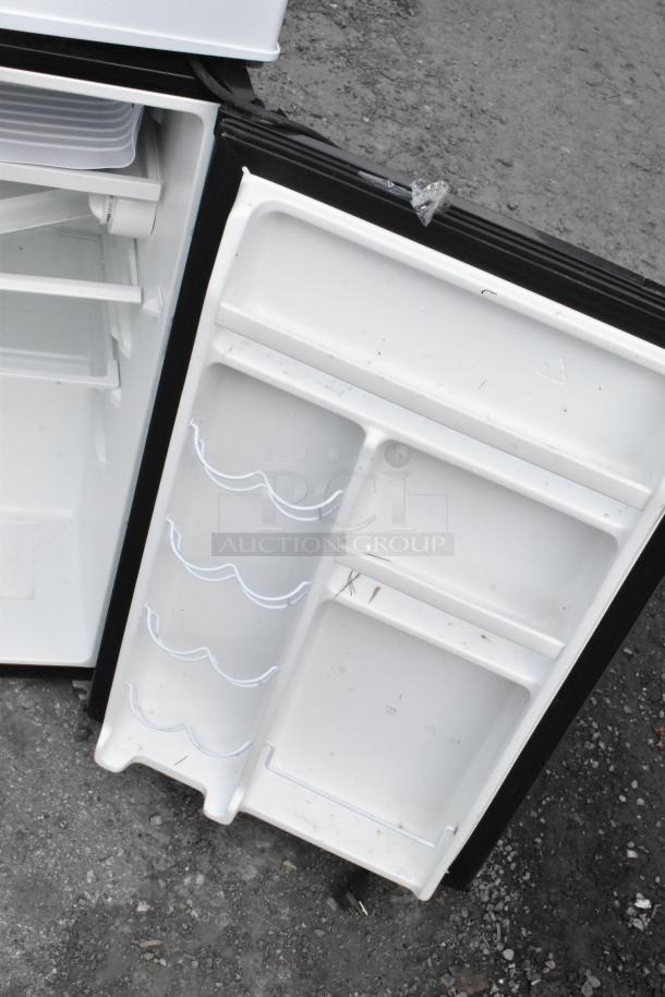 Four mini coolers, including Tramontina 80901/100, EdgeStar CMF151L-1, Galanz GL43S5. Open doors showing interior shelves.