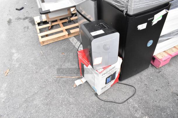 Two Frigidaire EFMIS183-SS Mini Coolers, DC 12V, AC 120V, shown on a pallet. Includes original packaging.