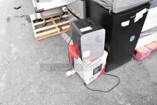 Two Frigidaire EFMIS183-SS Mini Coolers, DC 12V, AC 120V, shown on a pallet. Includes original packaging.
