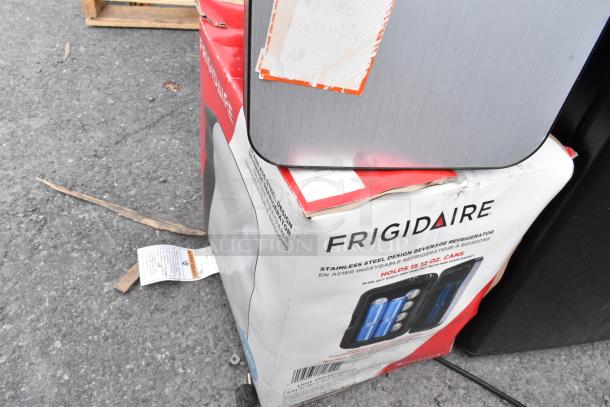 Frigidaire EFMIS183-SS Mini Cooler with DC 12V, AC 120V, holds 15 cans. Box slightly damaged, cooler appears intact.