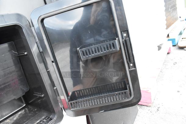 Frigidaire EFMIS183-SS Mini Cooler, open door view, black interior, shelf on door. DC 12V, AC 120V.