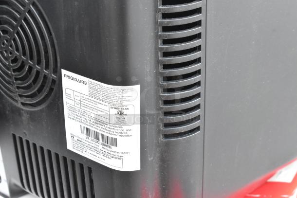 Frigidaire EFMIS183-SS mini cooler, black, label showing model and voltage details, new condition.