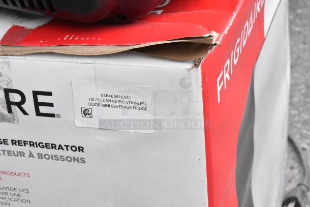 Frigidaire EFMIS183-SS Mini Cooler box, 15-can capacity, 10L, retro stainless finish, label shows DC 12V, AC 120V input.