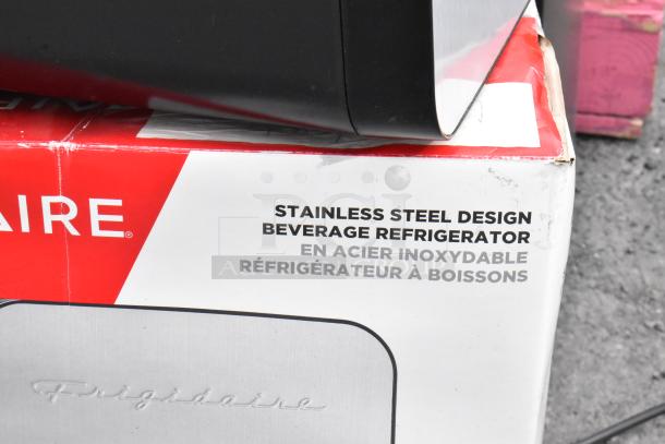 Frigidaire EFMIS183-SS Mini Cooler, stainless steel, 12V/120V, beverage refrigerator packaging showing brand logo.