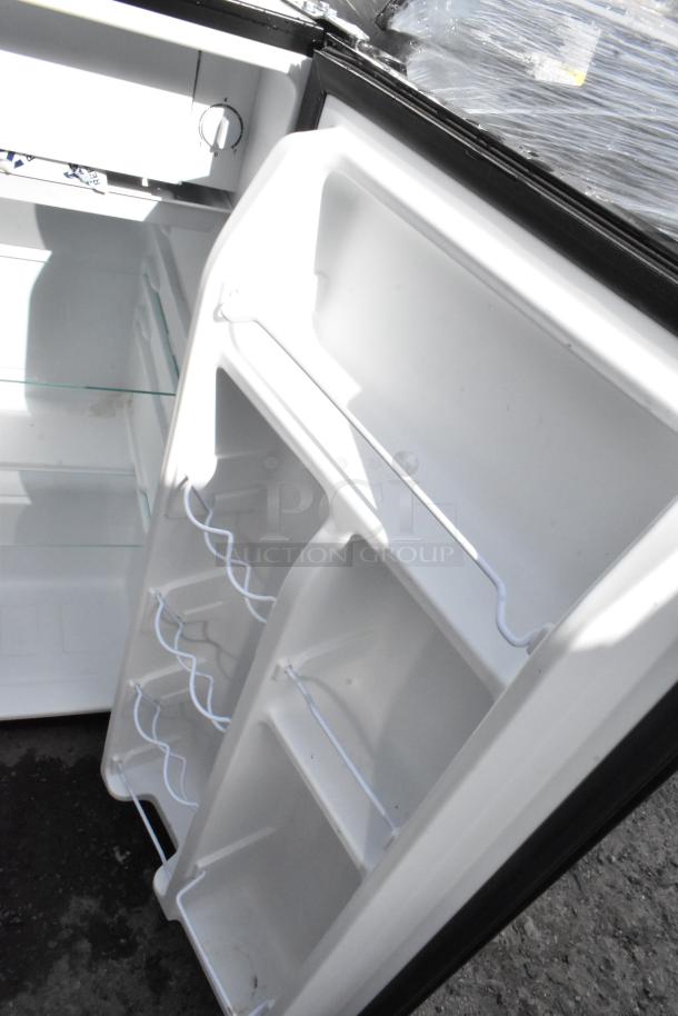 Open mini cooler interior showing shelves and storage racks. Auction includes Galanz GLR31TS1E02, GLR33MBKE23, GE WMR04BAPBB, Whirlpool WH31S1E.