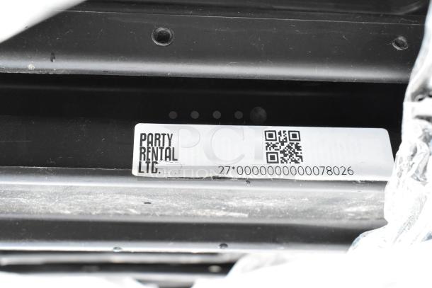 Alt text: Metal frame with "Party Rental LTD" label and QR code on 39 folding chairs in auction.