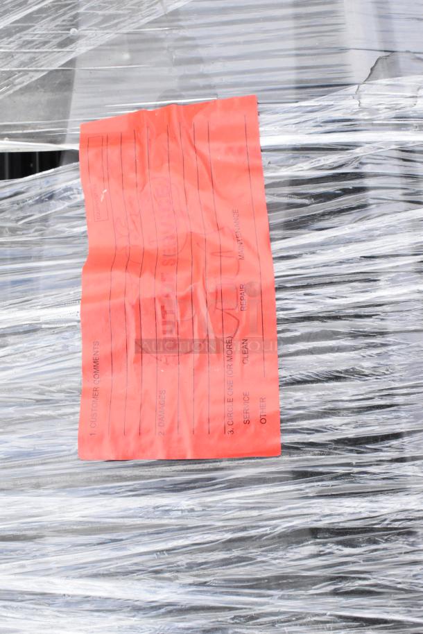 Pallet wrapped in clear plastic holds 39 folding chairs. A red "Out of Service" tag is visible, indicating service required.