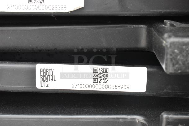 Stacked black folding chairs with visible labels from Party Rental Ltd., featuring QR codes and numeric identifiers.