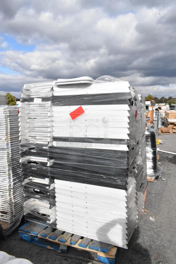 Stack of folding chairs, wrapped and stacked on pallets. Includes labels with red tags. Auction of 90 items total.