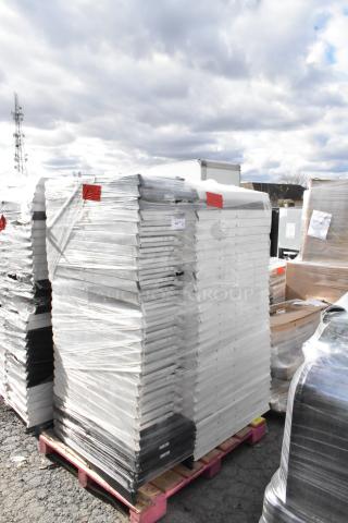 Stack of 90 folding chairs on pallet, wrapped in plastic for auction. White and black frames. Good condition.