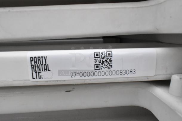 Alt text: "Stacked folding chairs with Party Rental LTD label and QR code, item number 270000000000083083."