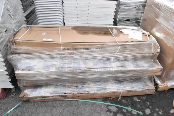 4 boxed 360SNZGD18 sneeze guards in protective wrapping, labeled as scratch and dent, resting on a pallet.