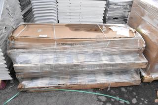 4 boxed 360SNZGD18 sneeze guards in protective wrapping, labeled as scratch and dent, resting on a pallet.