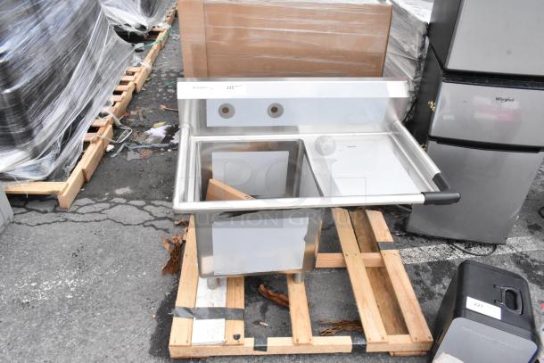 Regency 600S1181818R stainless steel single bay sink with right side drain board, new scratch and dent, on wooden pallet.