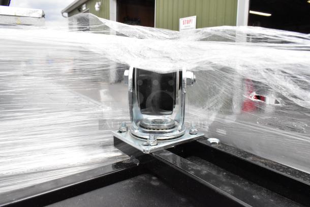 Brand new Lavex 475UAG153FRME black poly tilt truck, 1650 lb capacity. Scratch and dent condition with caster wheel visible.