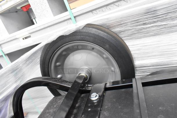 BRAND NEW Lavex Black Poly Tilt Truck, 1650 lb capacity, showing wheel detail and sturdy construction. Scratch and dent condition.