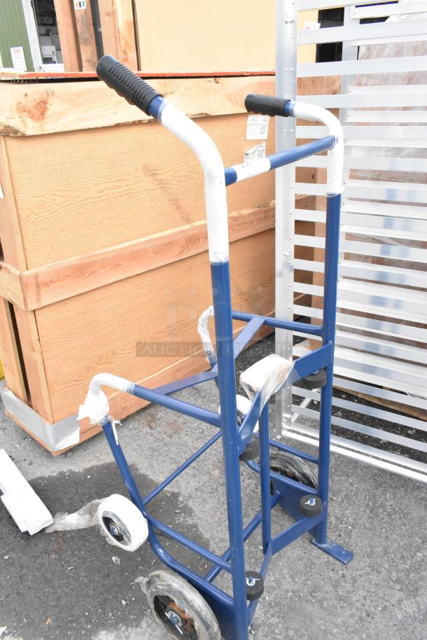 Blue metal barrel dolly, brand new with scratches and dents, protective wrapping on handles and wheels, durable design.