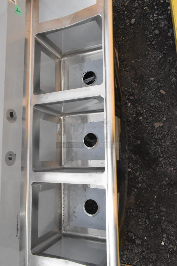 BRAND NEW Regency 600S31416212 stainless steel three-compartment sink, 70", with drainboards. Scratch and dent condition.