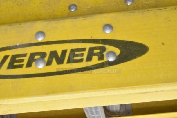 Brand new Werner 40' straight ladder, yellow, showing logo and visible rivets, slight scratches, and dents.