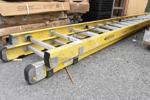 Brand new Werner 40' straight ladder with visible scratches and dents, yellow design, durable aluminum rails.