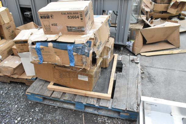 Damaged boxes of new items on a pallet, including Acopa stemless flute glasses and a BM176IB100 ingredient bin. Box wear visible.