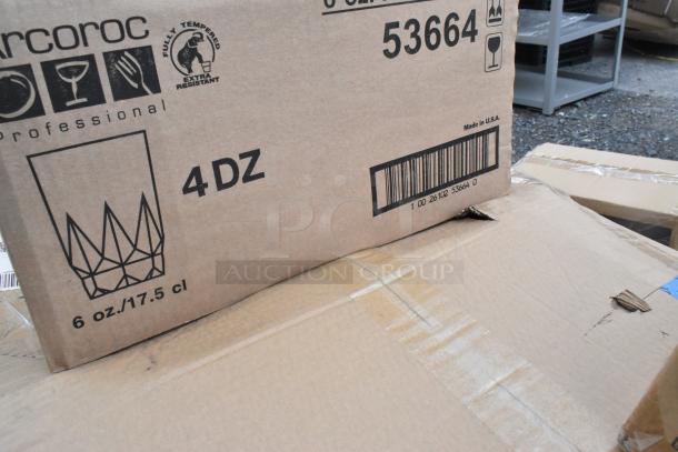 Cardboard box labeled "Arcoro 53664, 4DOZ, 6 oz/17.5 cl" indicating beverage glasses. Box slightly worn.