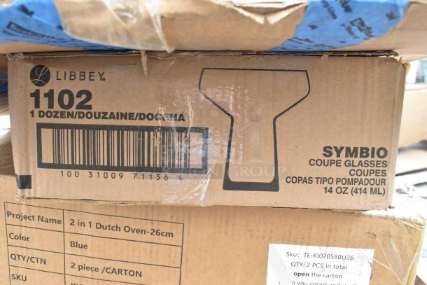 Cardboard box labeled Libbey Symbio 14 oz. Coupe Glasses, 1 dozen per case. Visible SKU barcode and product outline.