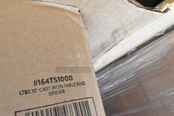 Cardboard box labeled #164TS1000 LT&S 10" Cast Iron Table Base Spider, showing light wear, on pallet.