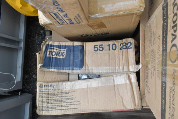 Boxes of Tork items with visible labels, including product number 5510282. Boxes show slight wear, indicating scratch and dent condition.