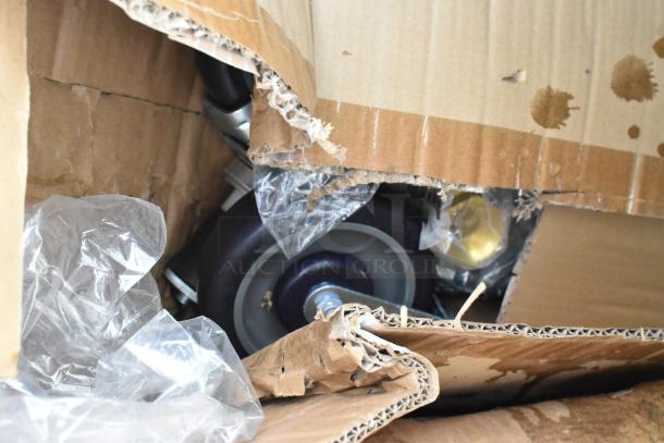 Brand new Regency 24" x 18" stainless steel portable ice bin, showing wheels, in a damaged cardboard box.