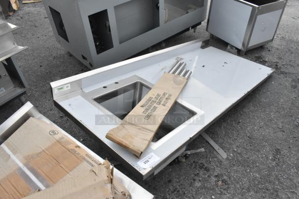 Brand new Regency 600ST3072L 30" x 72" stainless steel tabletop with left sink; minor scratches visible.