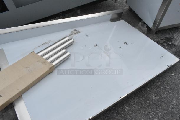 Brand new Regency 600ST3072L 30"x72" stainless steel work tabletop with sink, left side. Minor scratches visible.